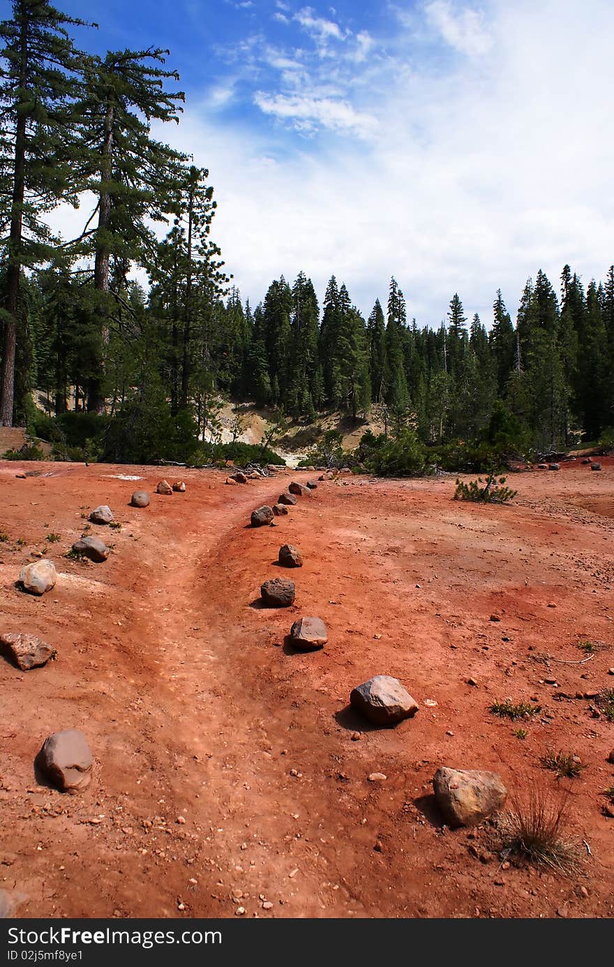 A rock lined path leading over the red dirt. A rock lined path leading over the red dirt