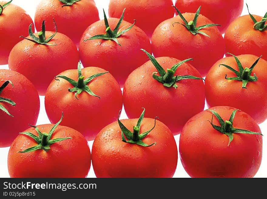 Red tomatoes just fresh from the refrigerator and temptingly displayed in rows. Red tomatoes just fresh from the refrigerator and temptingly displayed in rows.