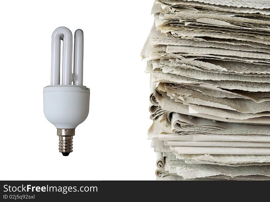 Light bulb and stack of old newspapers isolated on white background, signifying energy consumption, energy saving, renewable resources, and environmental conservation concepts. Light bulb and stack of old newspapers isolated on white background, signifying energy consumption, energy saving, renewable resources, and environmental conservation concepts.