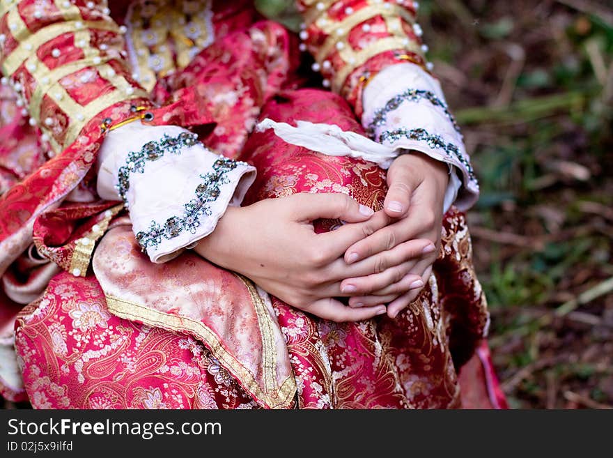 Girl hands and medieval red dress