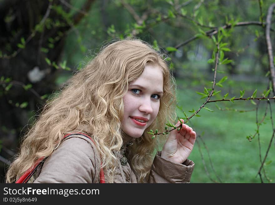 Girl and the branch with leaf buds