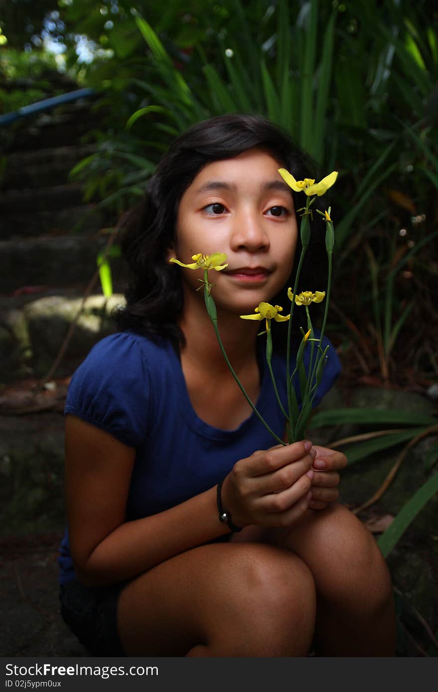 Young lady holding yellow flowers. Young lady holding yellow flowers