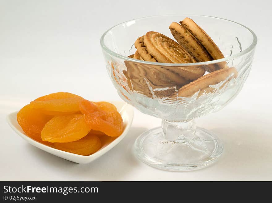 Dried Apricots On Plate And Cookies In A Vase