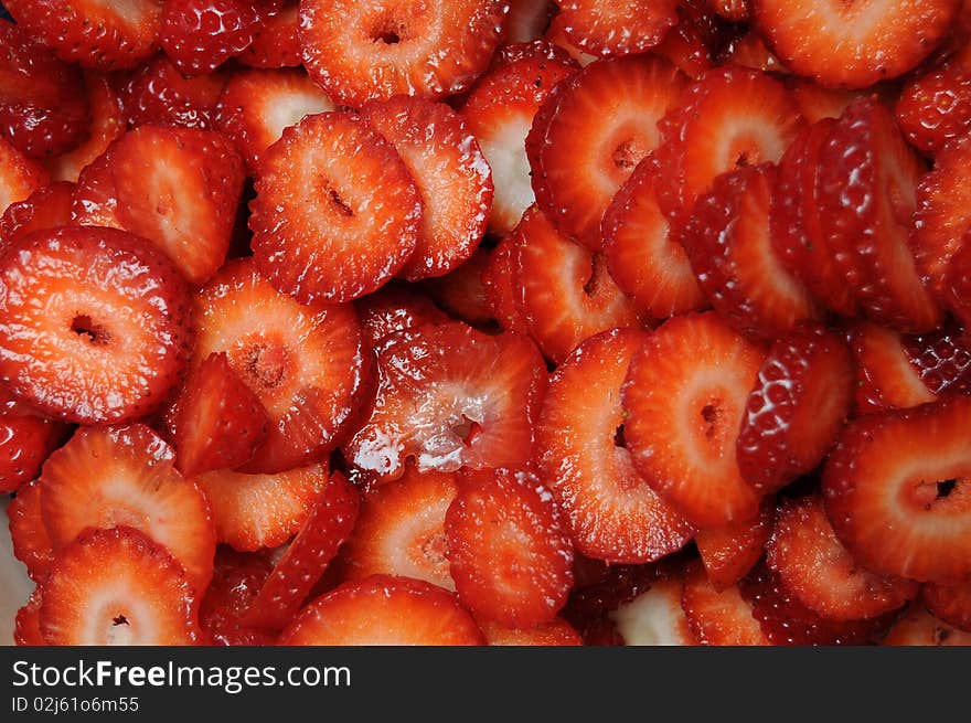 Closeup of lots of fresh shiny sliced and diced strawberries. Closeup of lots of fresh shiny sliced and diced strawberries