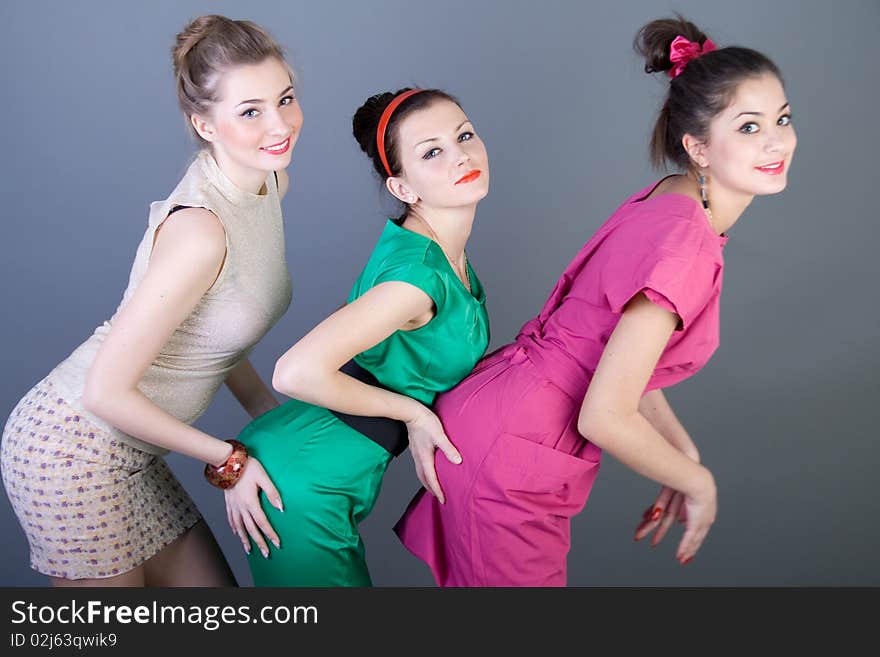 Three happy retro-styled girls studio shot