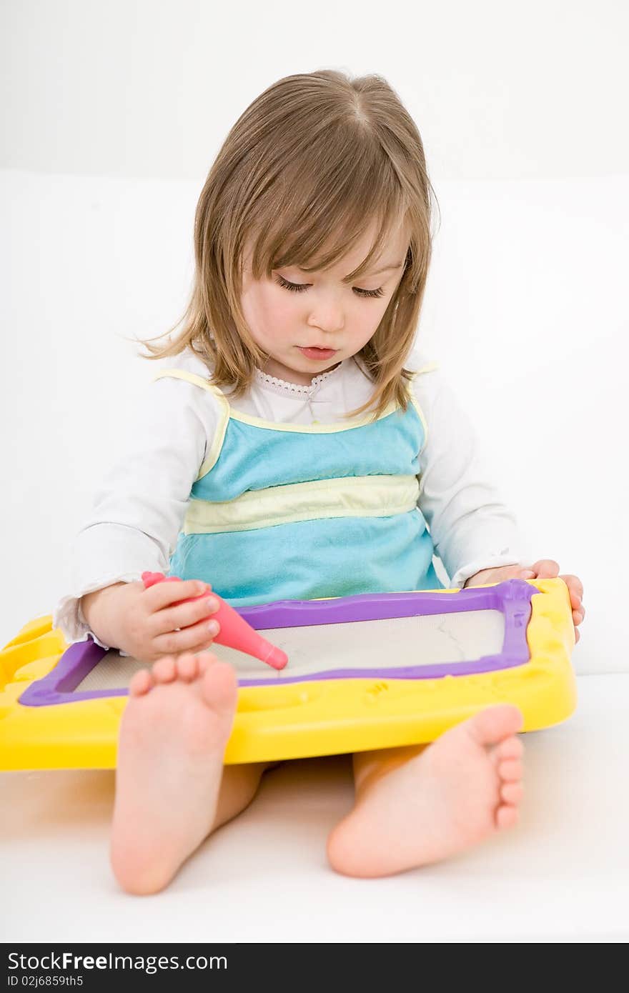 Sweet happy little girl drawing