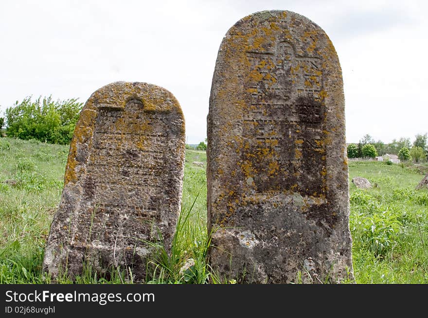 Old cemetery against a backdrop of a green grass