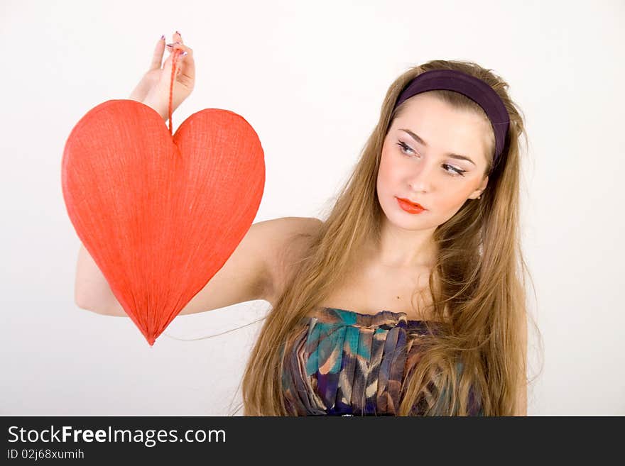 Beautiful woman holding red heart