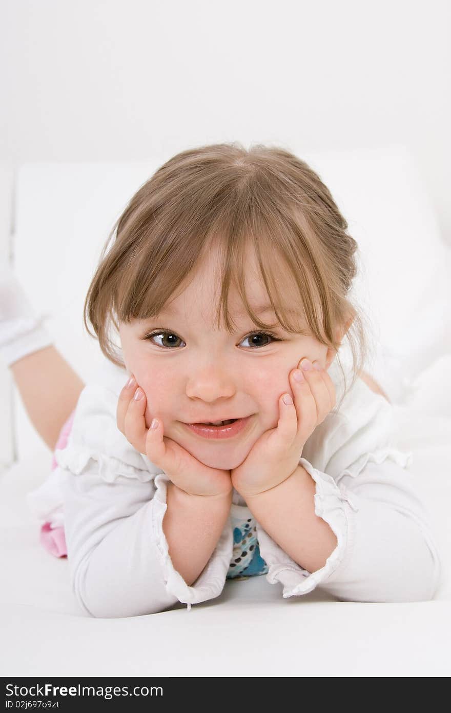 Sweet happy little girl on sofa