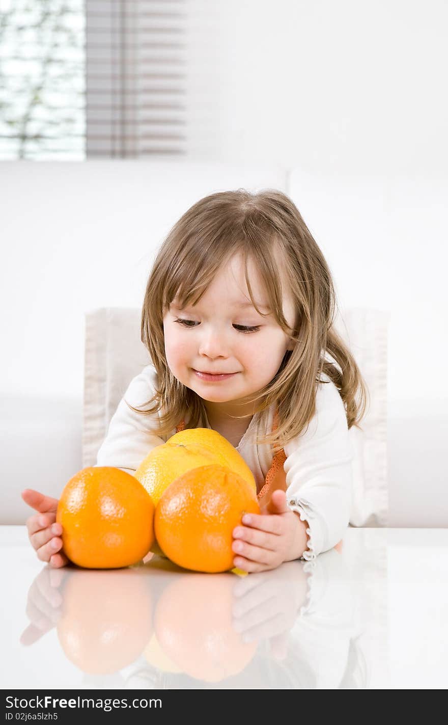 Sweet happy little girl with fruits