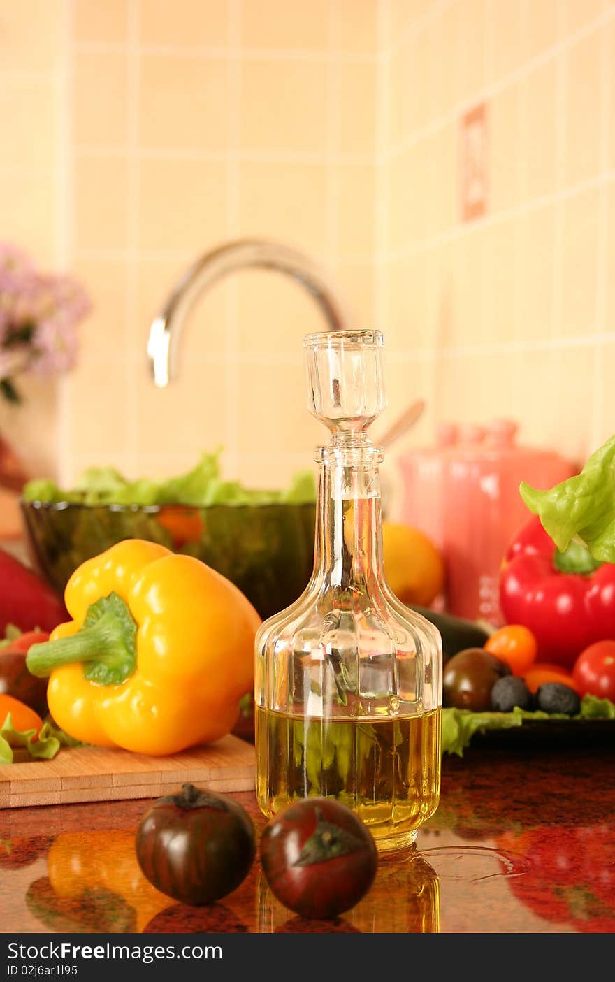 Fresh vegetables and olive oil on a kitchen table. Fresh vegetables and olive oil on a kitchen table