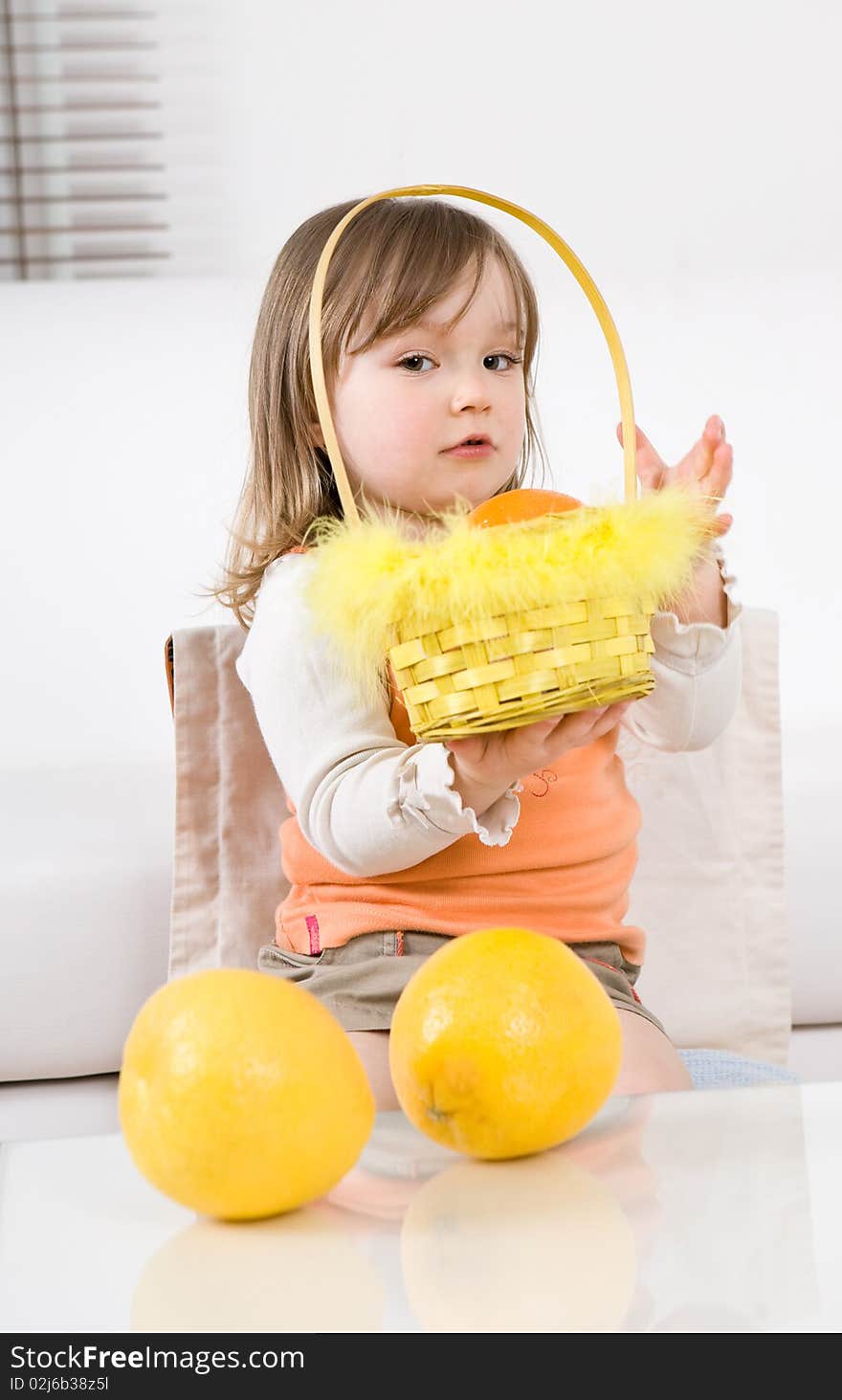 Sweet happy little girl with fruits