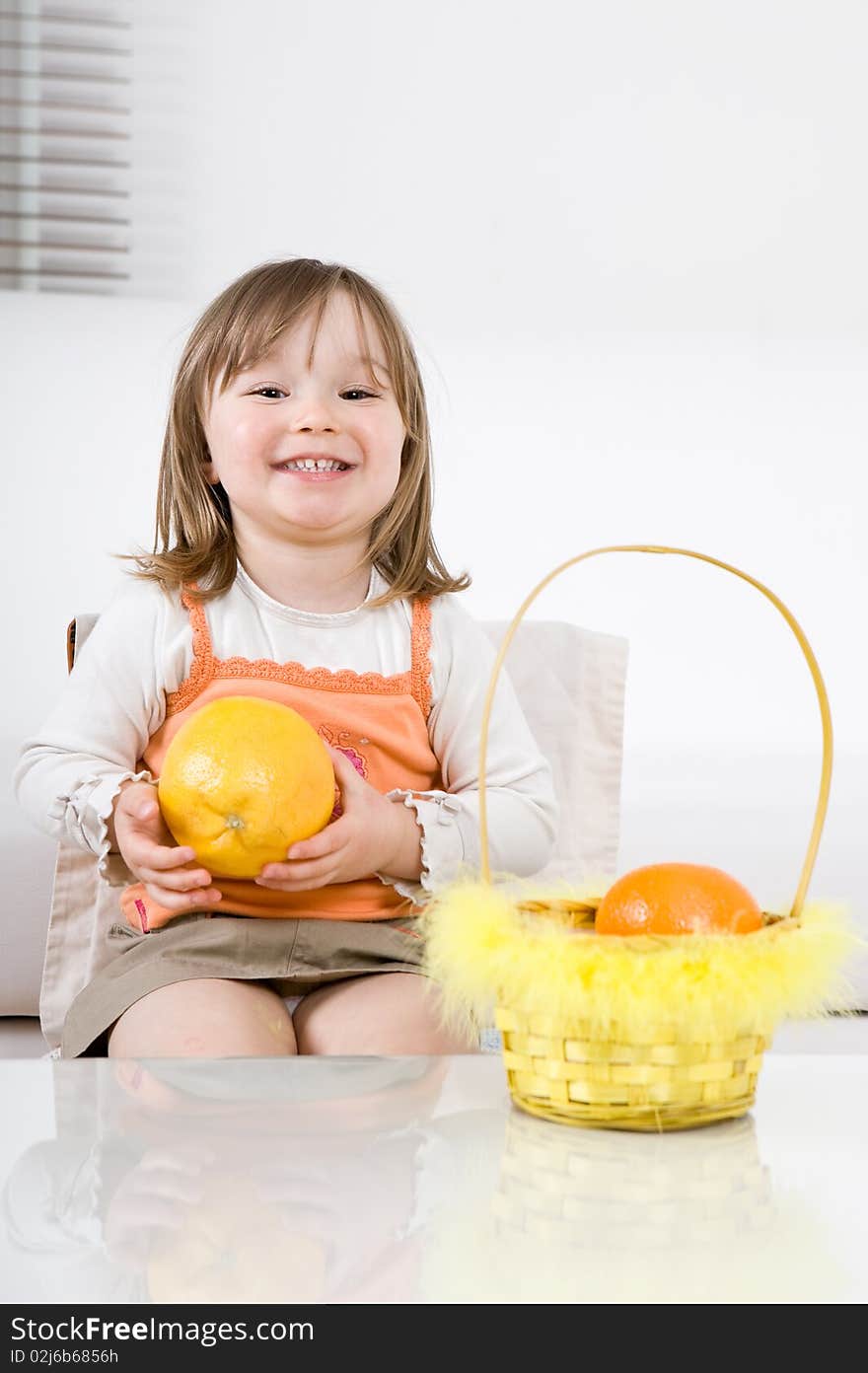 Sweet happy little girl with fruits