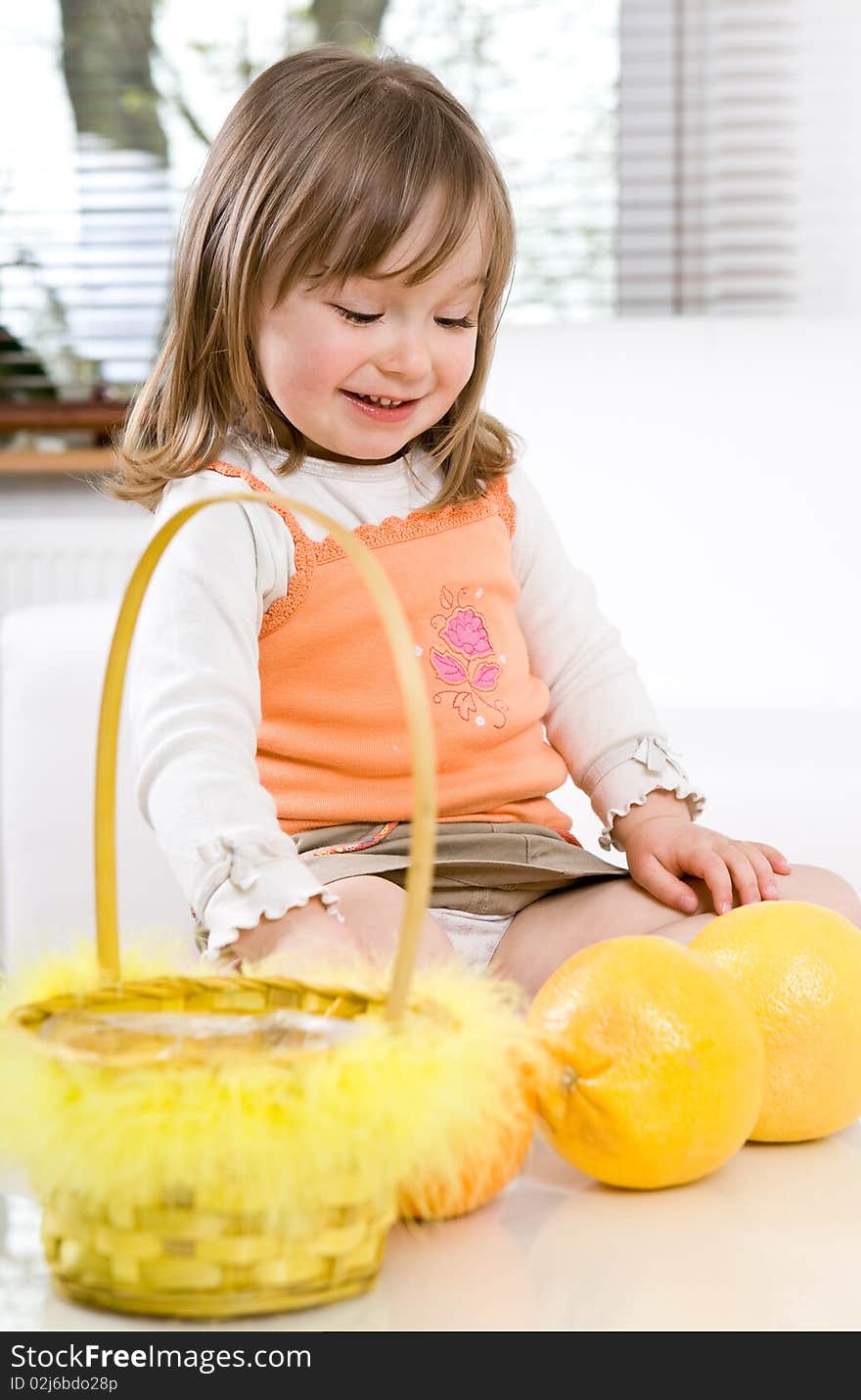 Sweet happy little girl with fruits