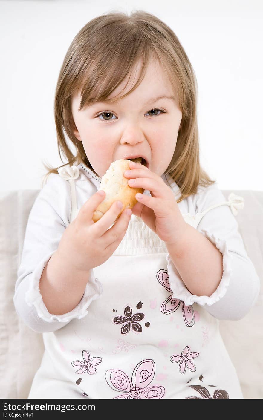 Sweet happy little girl eating