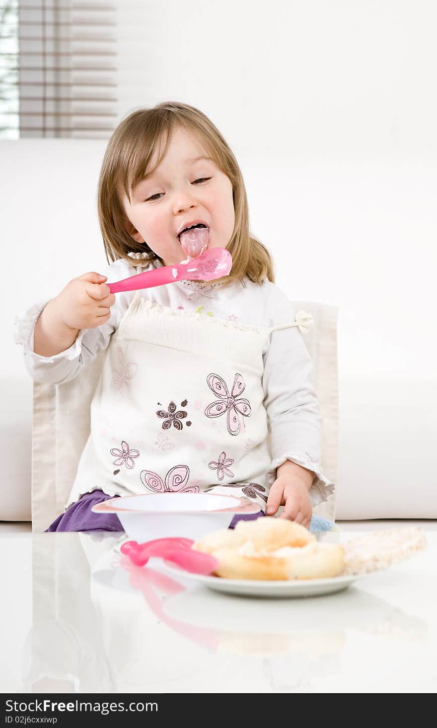 Sweet happy little girl eating