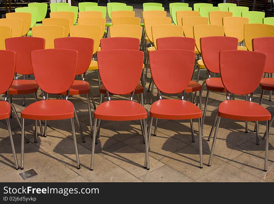 Colored chairs arranged in rows. Colored chairs arranged in rows