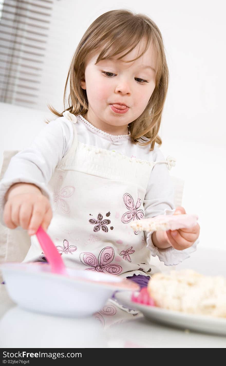 Sweet happy little girl eating