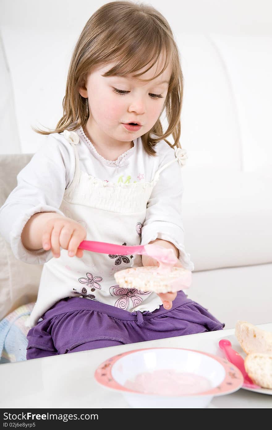 Sweet happy little girl eating