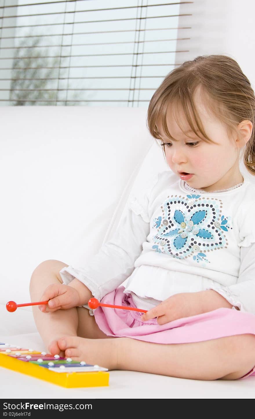 Sweet happy little girl with instrument