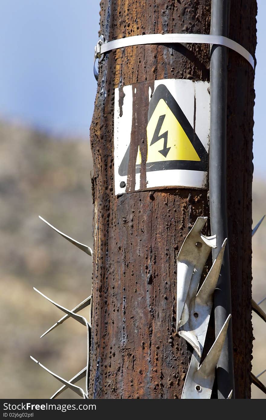 A wooden electricity supply pole for an AC transformer on a farm