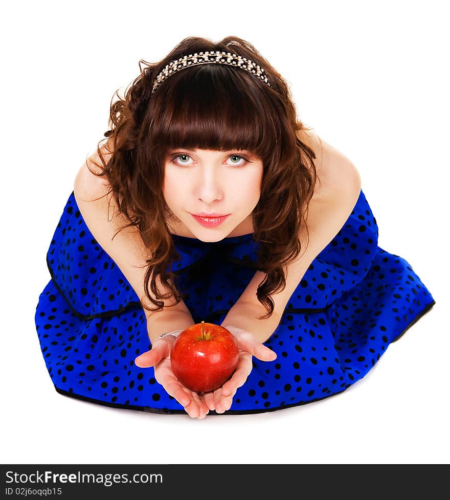 Lovely girl in a bдue dress and brilliant diadem with a red apple. Lovely girl in a bдue dress and brilliant diadem with a red apple