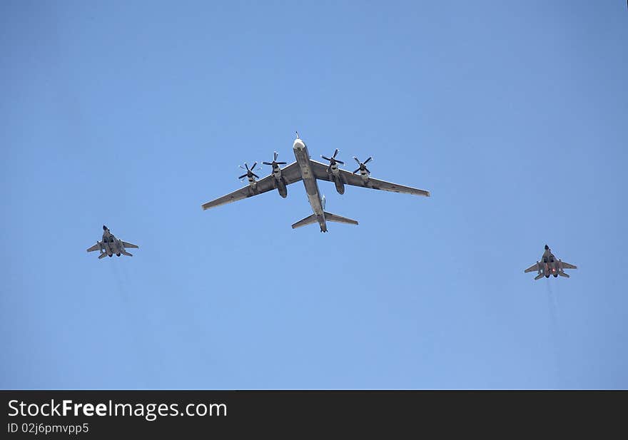 Strategic  Bomber Flies With Two Fighters