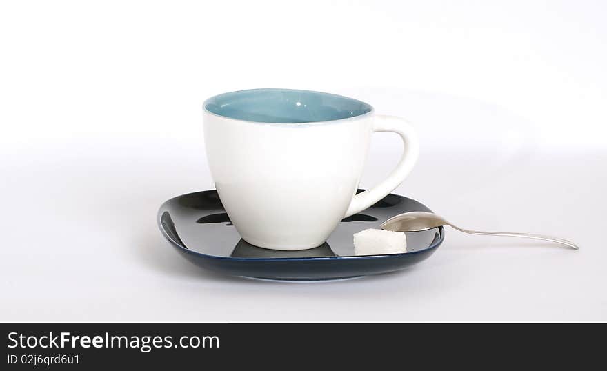 White tea cup with a spoon on the saucer