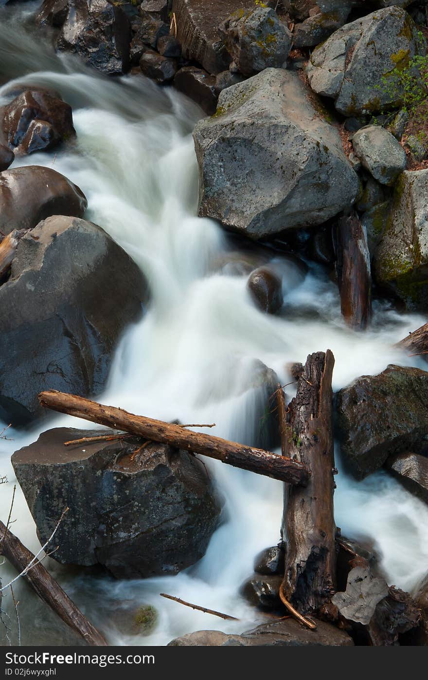 Battle Creek surging through boulders and logs