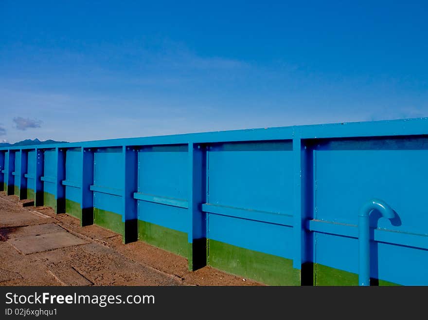 Blue metal wall near sea. Blue metal wall near sea