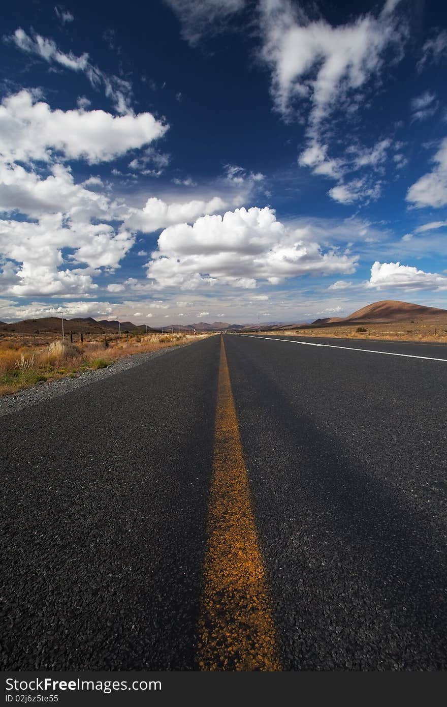 Image of a road in the karoo desert of South Africa with Clouds. Image of a road in the karoo desert of South Africa with Clouds