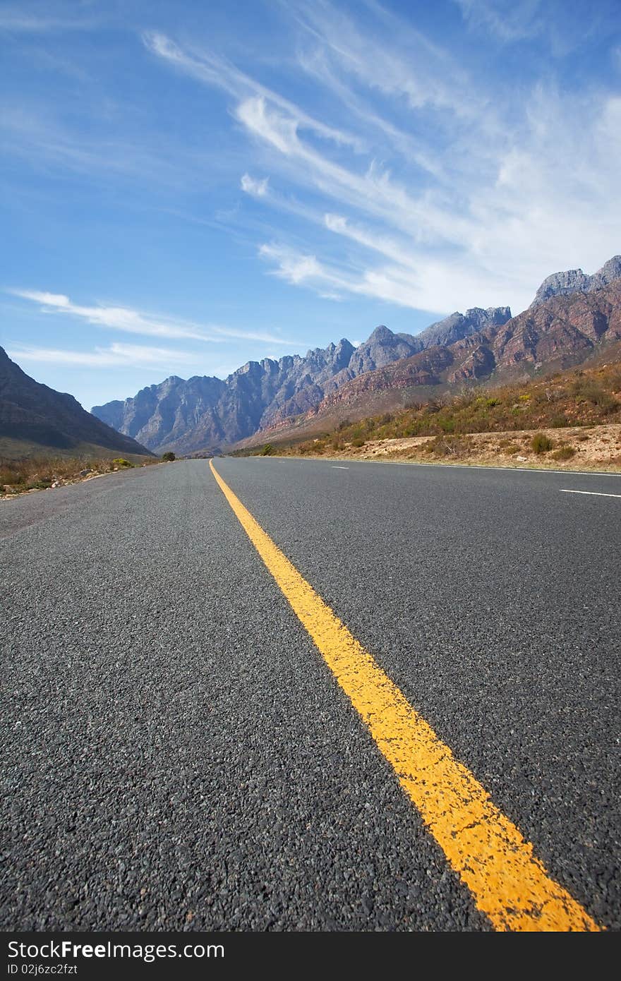 Road through the mountains in South Africa in the Western Cape with great High clouds. Road through the mountains in South Africa in the Western Cape with great High clouds