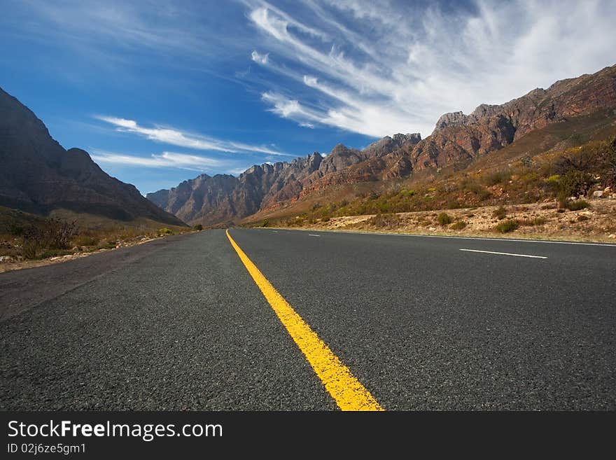 Road through the mountains in South Africa in the Western Cape with great High clouds. Road through the mountains in South Africa in the Western Cape with great High clouds