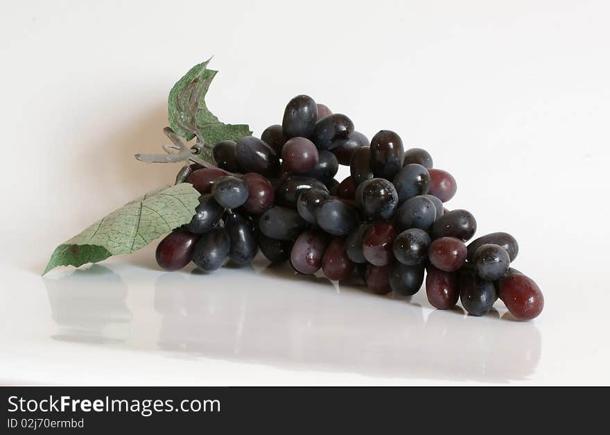 Still Life with ripe grapes on a white background