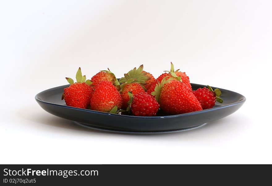 Red Strawberries On A Black Plate