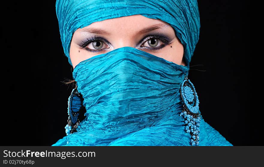 Closeup of blue woman's eyes with east make-up