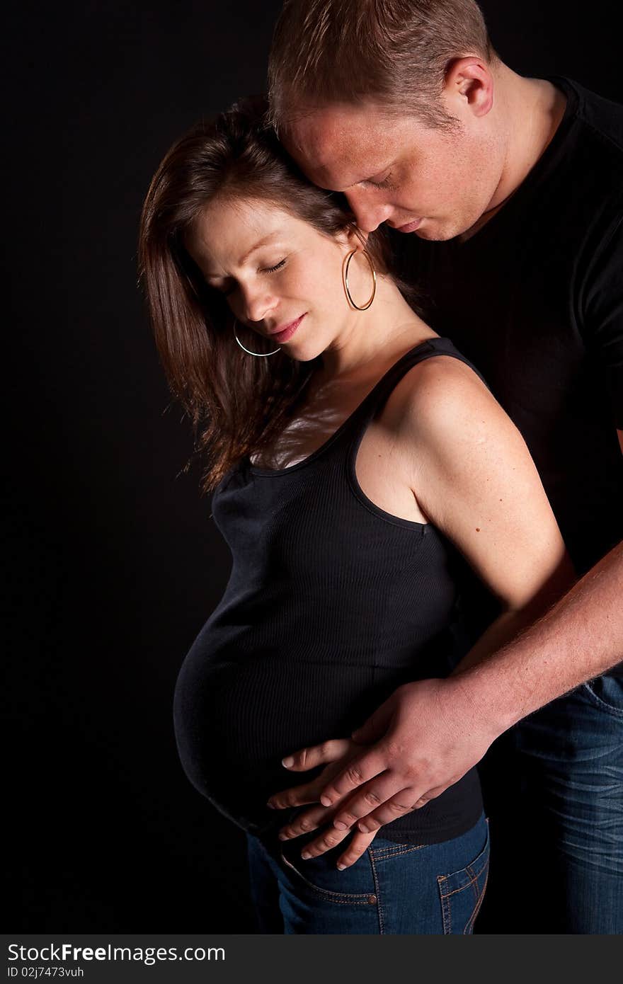 Young couple with the main focus on the pregnant beautiful woman. Young couple with the main focus on the pregnant beautiful woman.