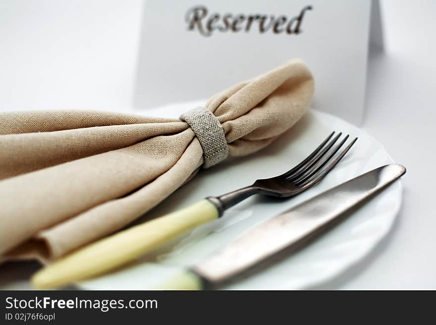 An image of knife and fork on a plate. An image of knife and fork on a plate