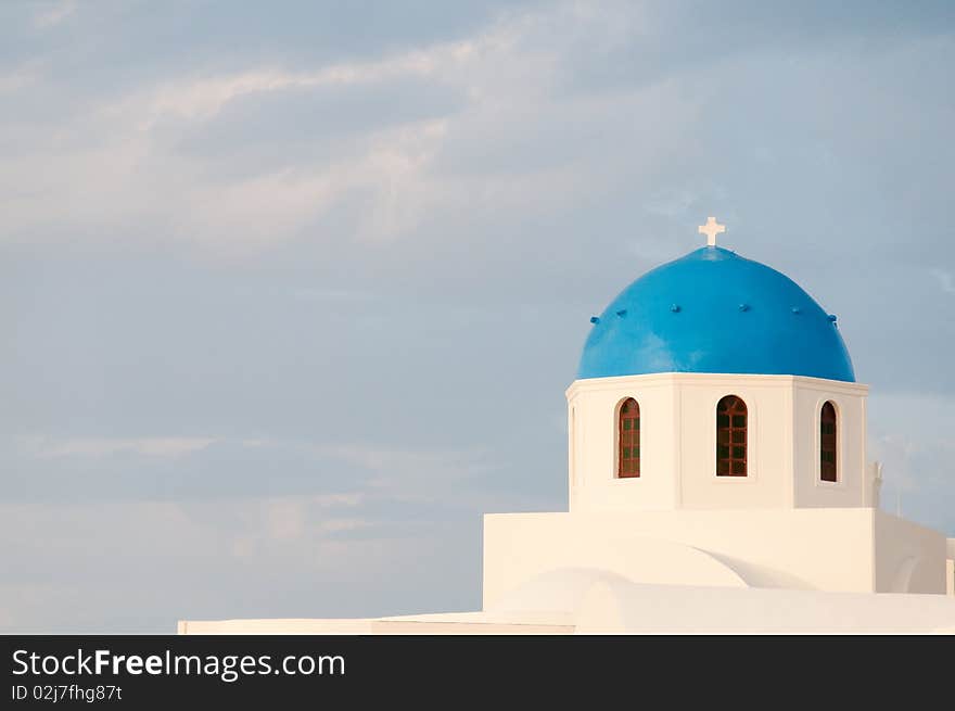 Greek church in santorini greece with a cross