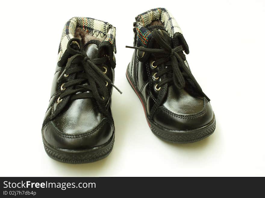 A pair of baby shoes , isolated in the white background