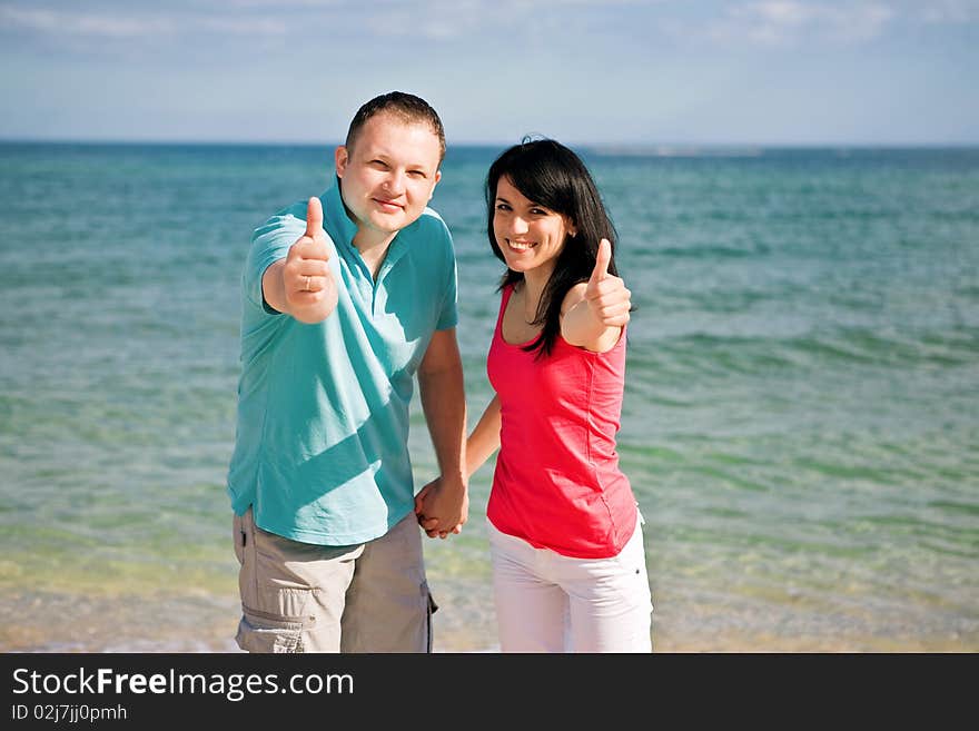 A couple on beach have fun