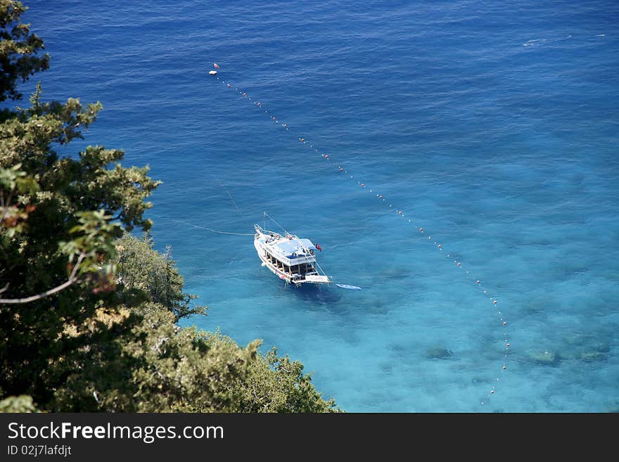 The top view on the sea and a yacht standing on an anchor. The top view on the sea and a yacht standing on an anchor