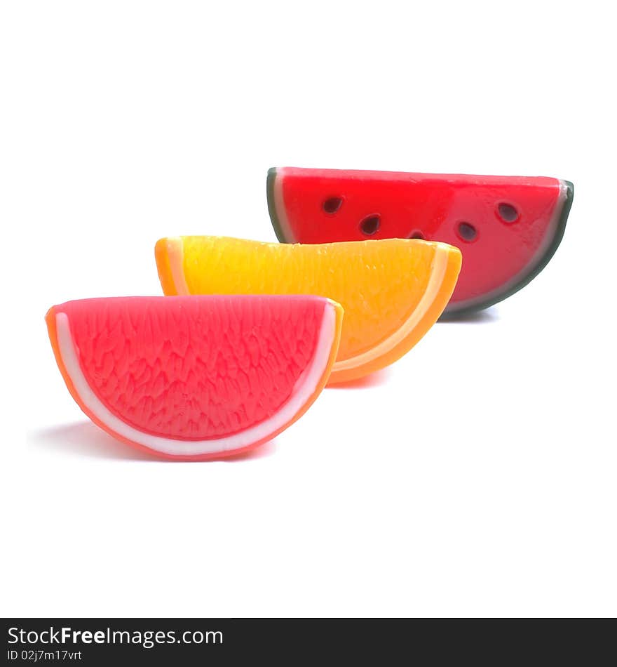 Lobule of grapefruit, orange, water-melon on a white background