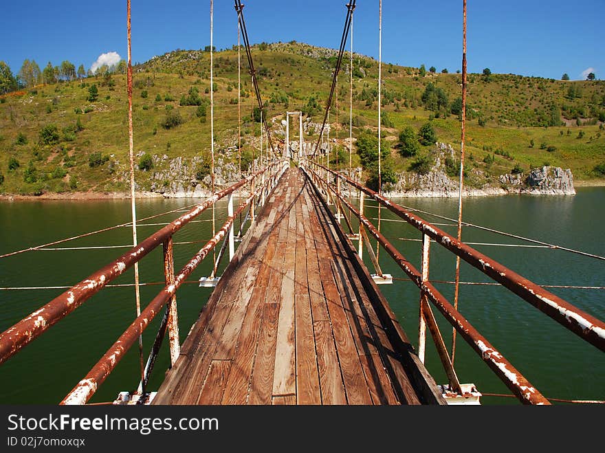 Old rusty bridge on river