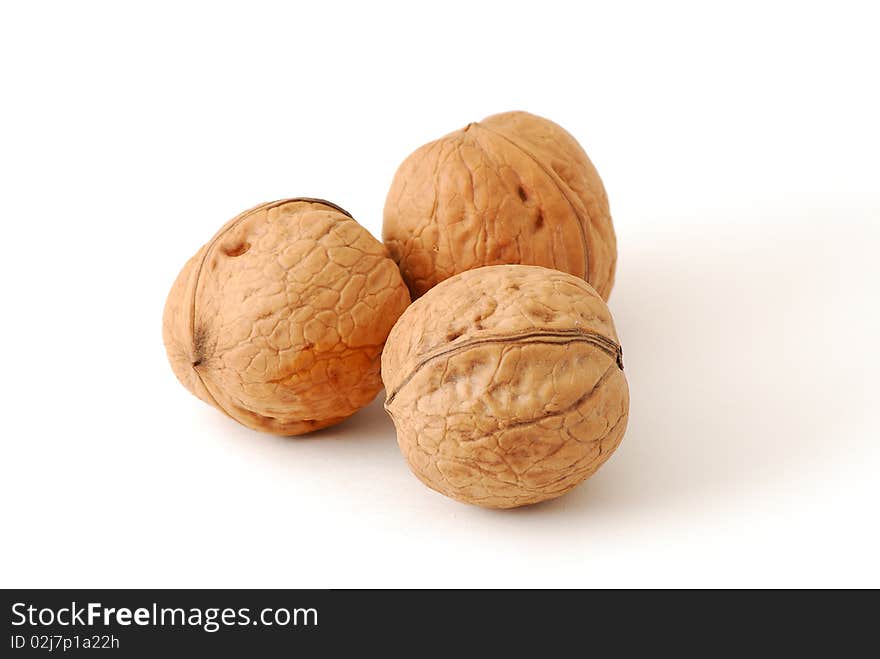 Three walnuts isolated on white background