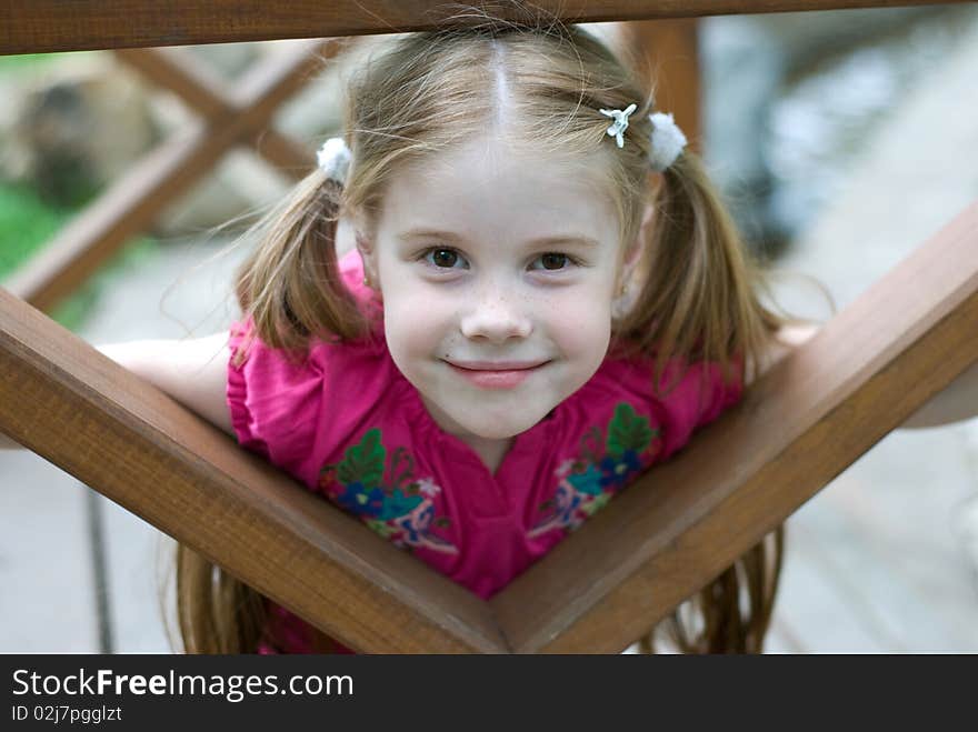 Smiling little girl in a wooden structures