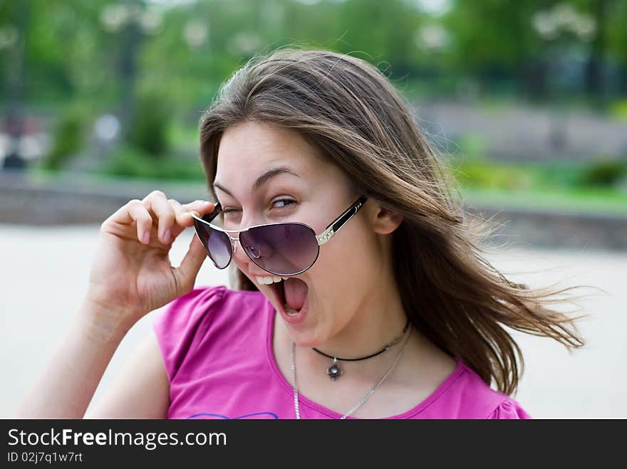 Portrait of a laughing teenage girl in sunglasses. Portrait of a laughing teenage girl in sunglasses