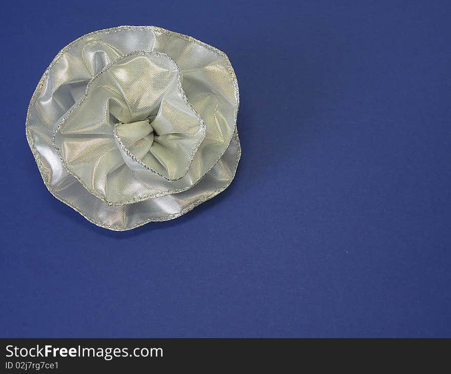 Silver ribbon-flower isolated on blue