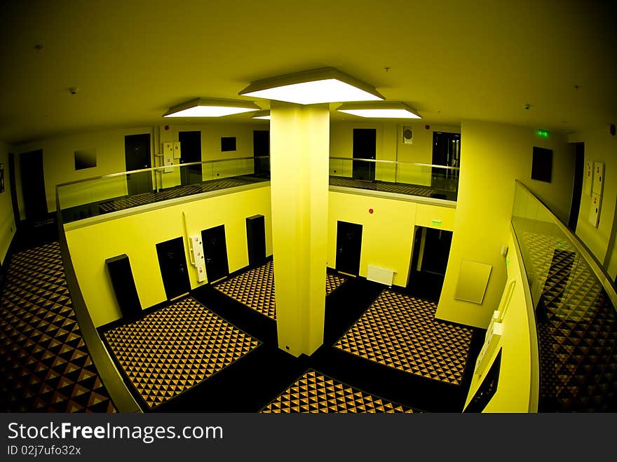 Spacious internal hall in a modern hotel in funky yellow light. Spacious internal hall in a modern hotel in funky yellow light