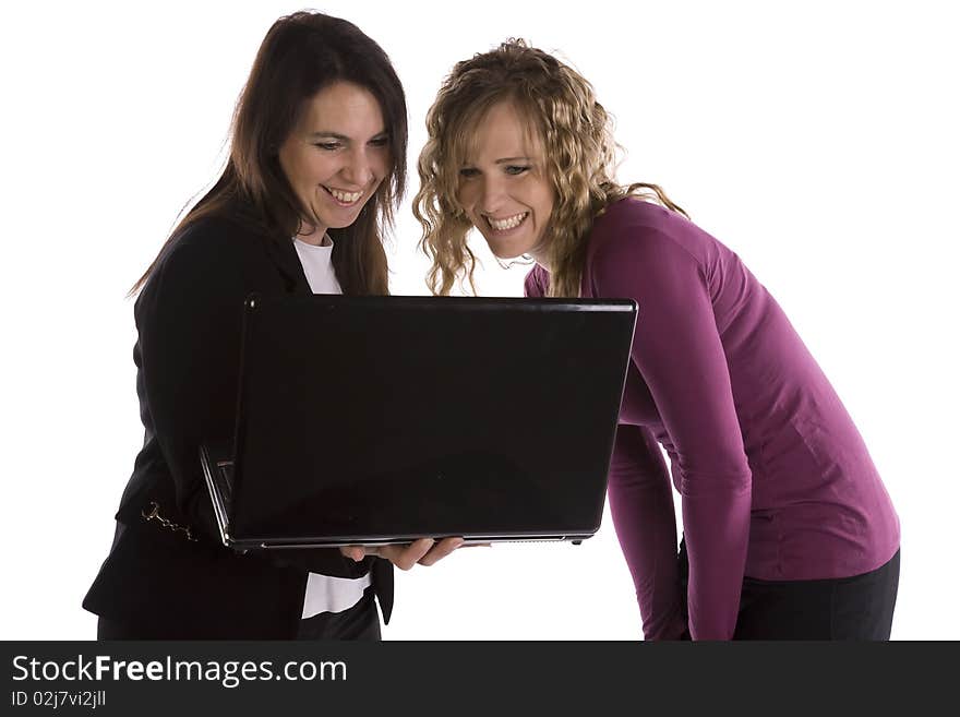 Two business women looking at a project on the computer with excited expressions on their faces. Two business women looking at a project on the computer with excited expressions on their faces.